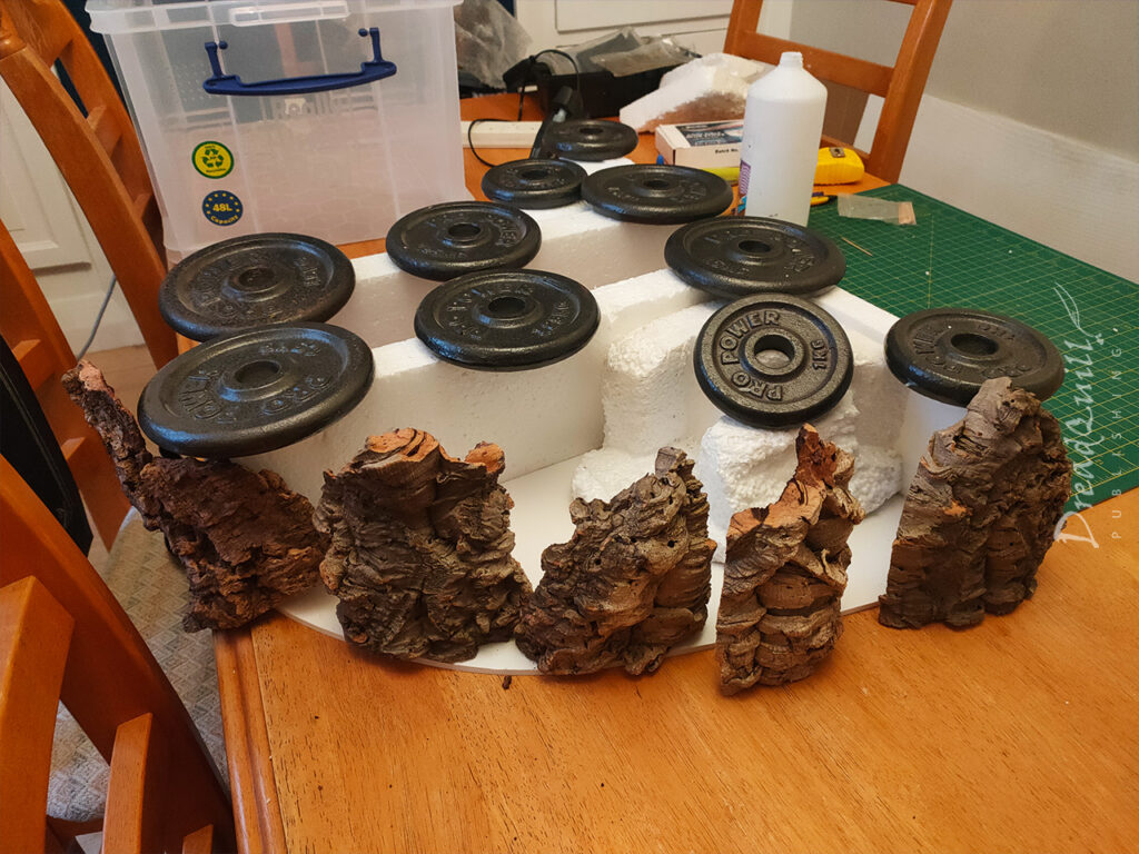 WIP ash wastes modular hills made of polystyrene and cork bark, weighed down with metal weights