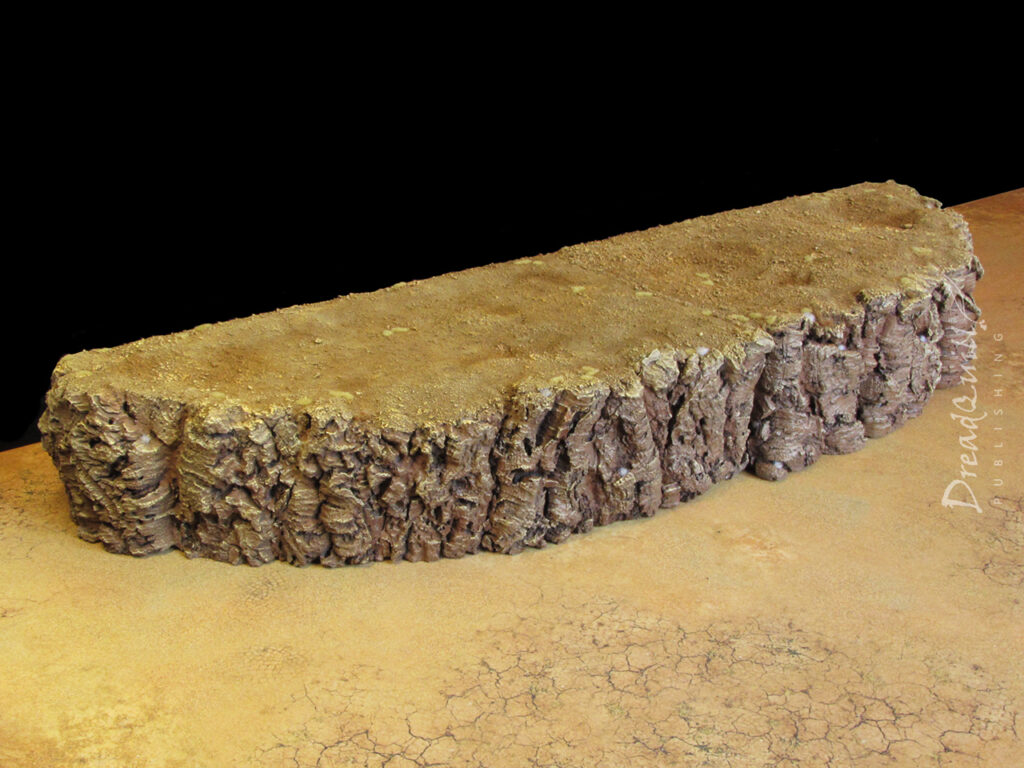 Ash waste modular hills painted a sandy brown against a black background, arranged wide