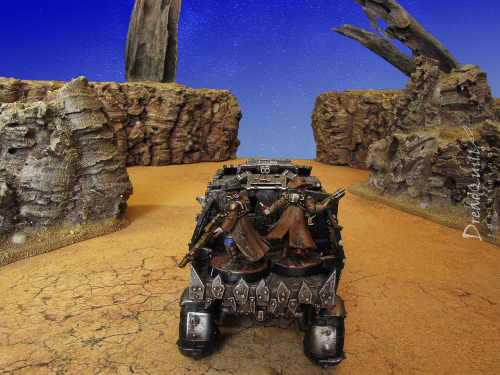 Two necromunda cowboys in the back of a vehicle driving towards a desert blue sky, ash waste hills surrounding them