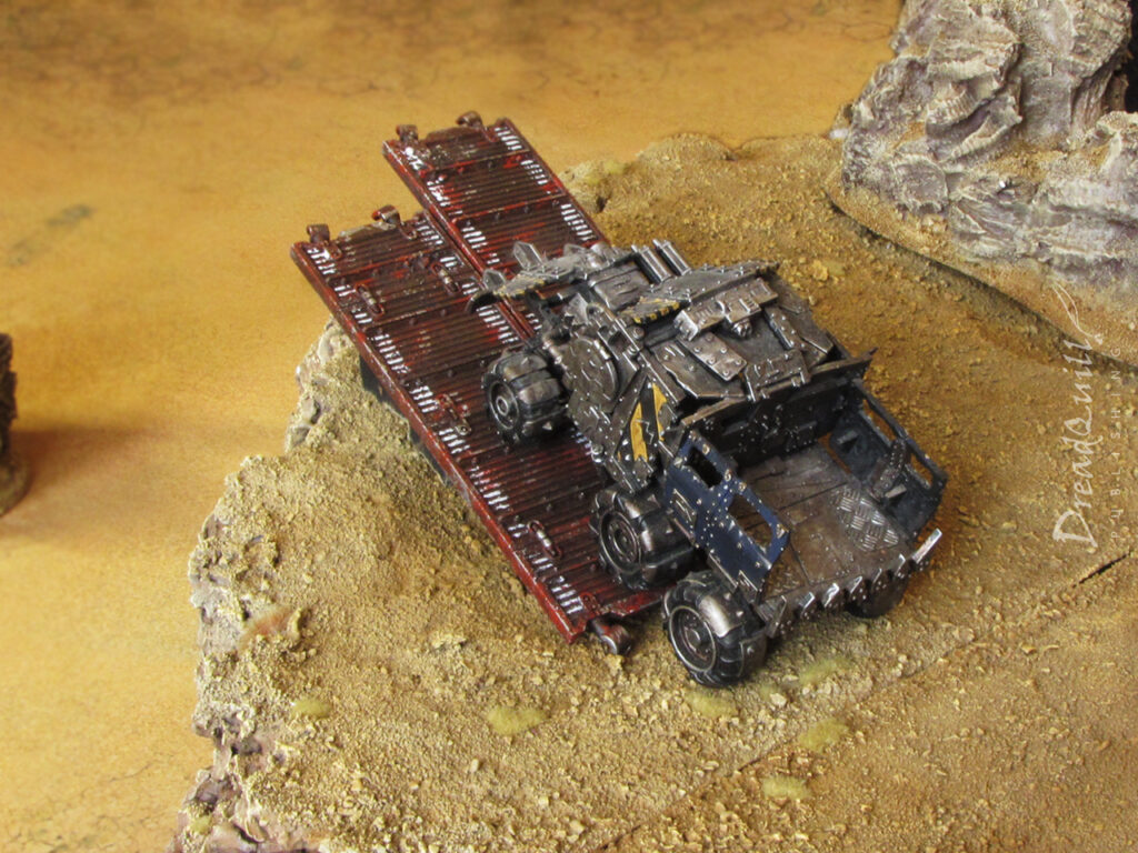 A vehicle atop an ash waste modular hill ramping off some platforms to the chasm below